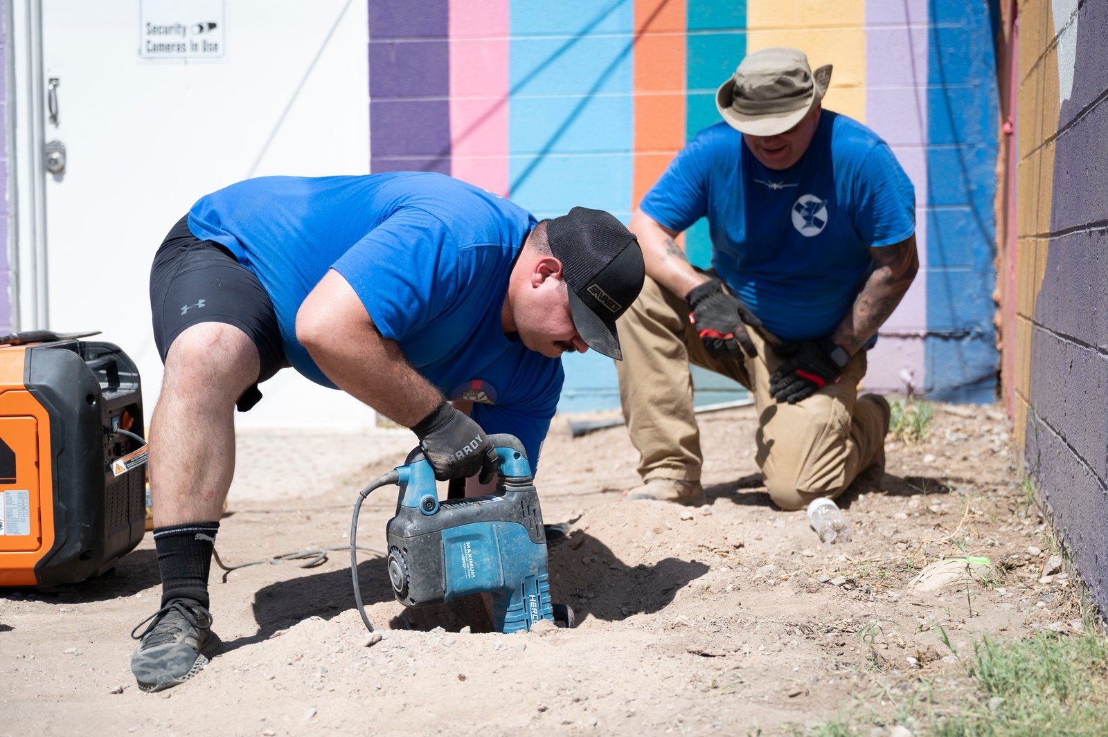 Two volunteers work together on a community clean-up in Alamogordo.